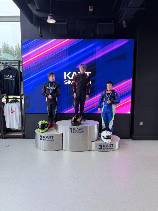 Three drivers celebrating on the Kart Silverstone podium